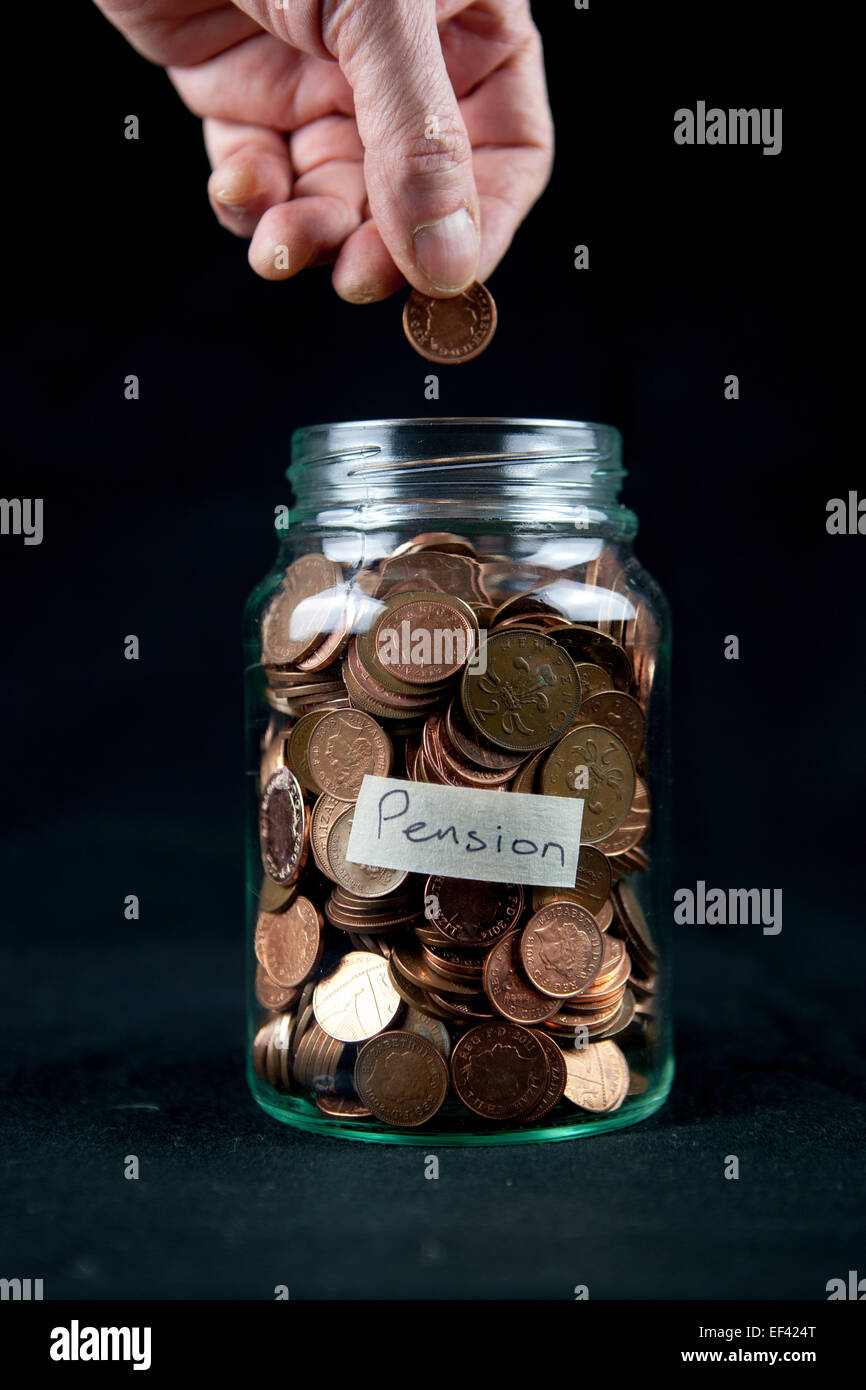 Adding a penny to a pension pot. Stock Photo