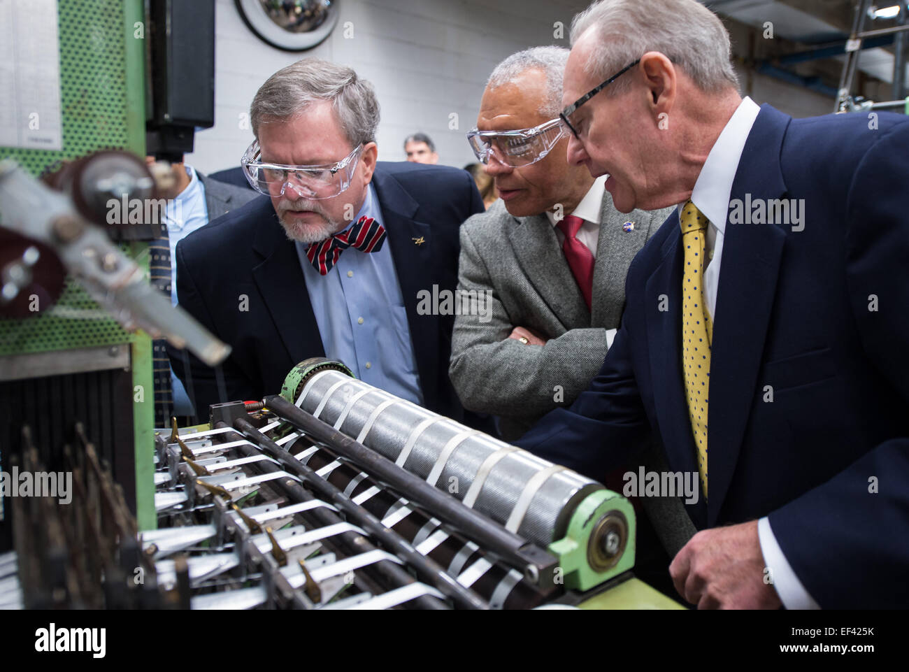 Vice President and Orion program manager for Lockheed Martin space systems company Mike Hawes, left, NASA Administrator Charles Bolden, center, and Bally Ribbon Mills (BRM) President Ray Harries talk during a tour of the BRM manufacturing facility on Friday, Jan. 9, 2015 in Bally, PA. BRM is weaving the multifunctional 3D thermal protection system padding used to insulate and protect NASA's Orion spacecraft. NASA's recently-tested Orion spacecraft will carry astronauts to Mars and return them safely back to Earth with the help of BRM technology. New woven composite materials are an advanced sp Stock Photo
