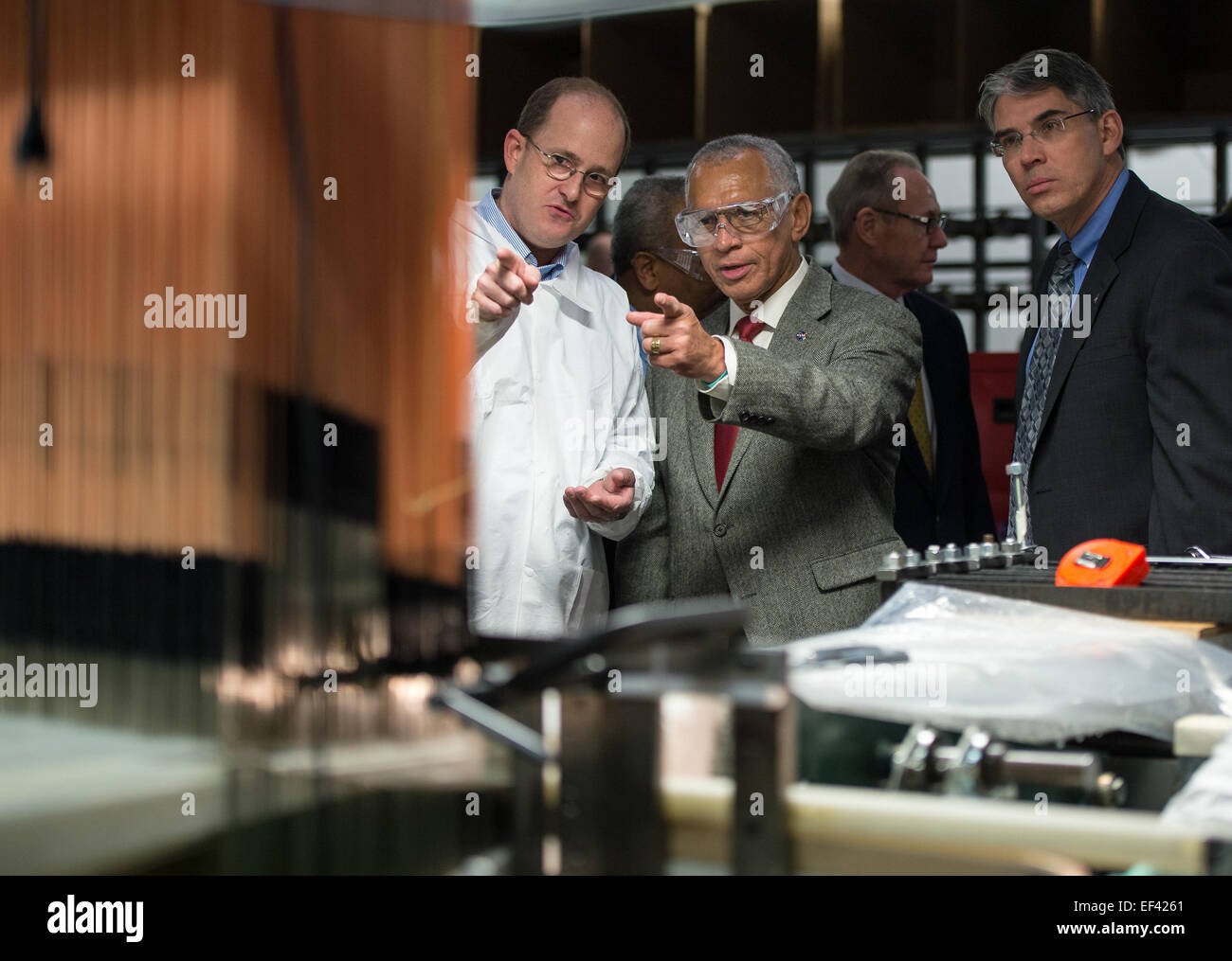 Bally Ribbon Mills (BRM) Senior R&amp;D Engineer Curt Wilkenson, left, answers questions by NASA Administrator Charles Bolden, center, as Associate Administrator of the Space Technology Mission Directorate Michael Gazarik looks on, during a tour of the BRM facility on Friday, Jan. 9, 2015 in Bally, PA. BRM is weaving the multifunctional 3D thermal protection system padding used to insulate and protect NASA's Orion spacecraft. NASA's recently-tested Orion spacecraft will carry astronauts to Mars and return them safely back to Earth with the help of BRM technology. New woven composite materials Stock Photo