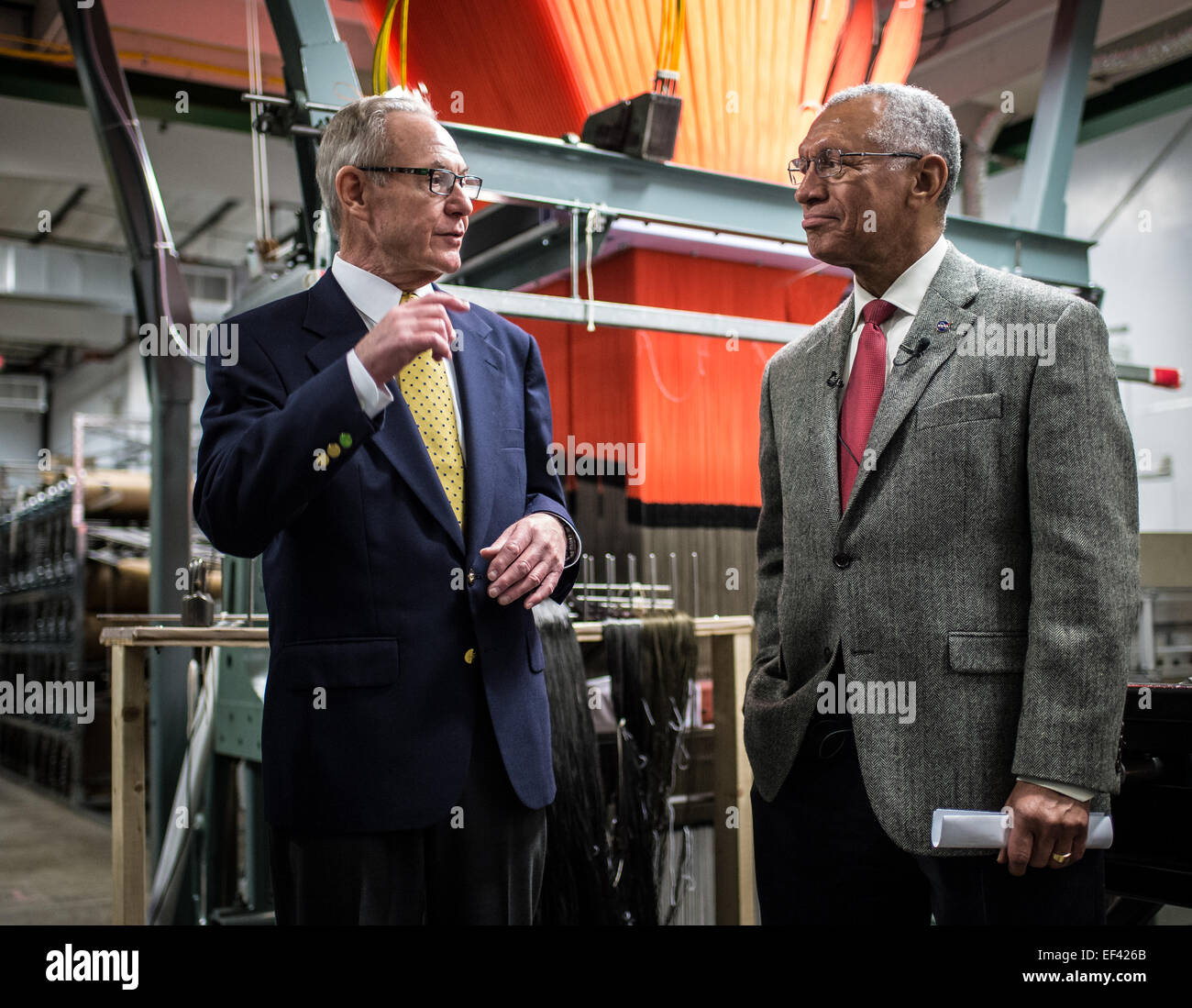 Bally Ribbon Mills (BRM) President Ray Harries, left, gives the history of  BRM to NASA Administrator Charles Bolden, and journalist, during a tour of  the BRM manufacturing facility on Friday, Jan. 9,