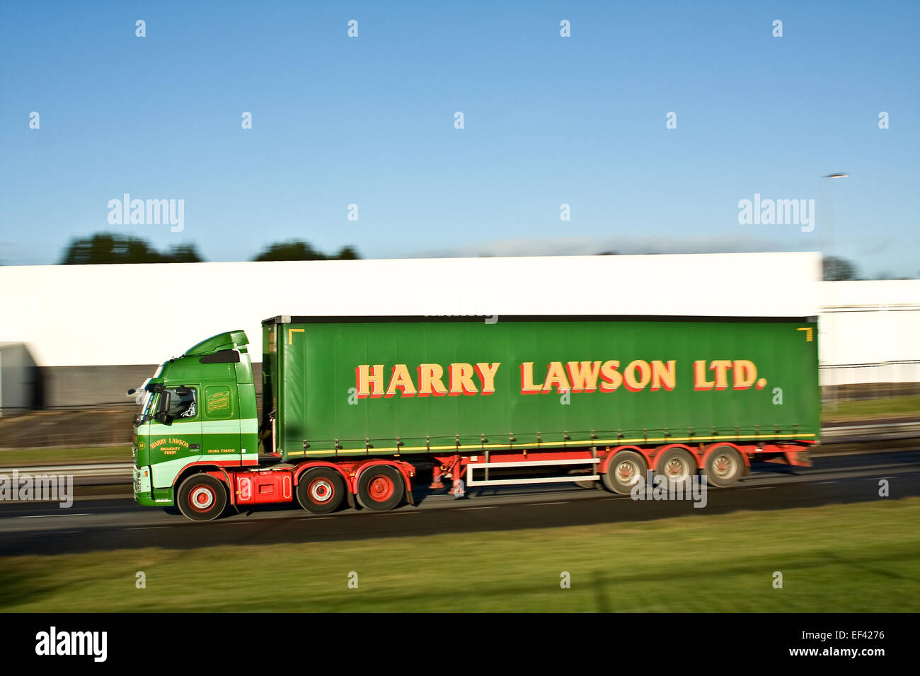A 'Harry Lawson Ltd' articulated haulage lorry travelling along the Kingsway West Dual Carriageway in Dundee, UK Stock Photo