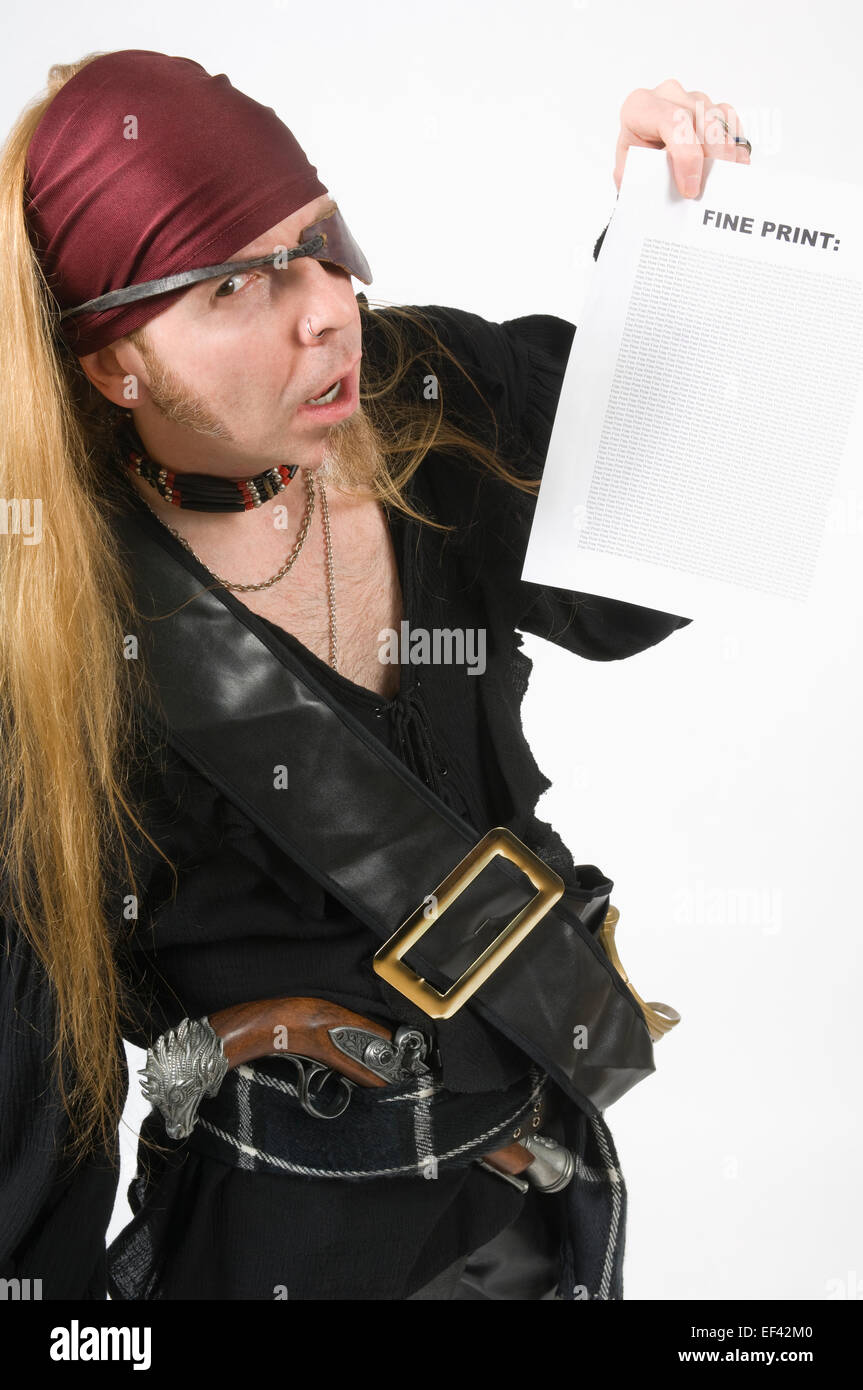 Man wearing a pirate costume while looking at the fine print Stock Photo