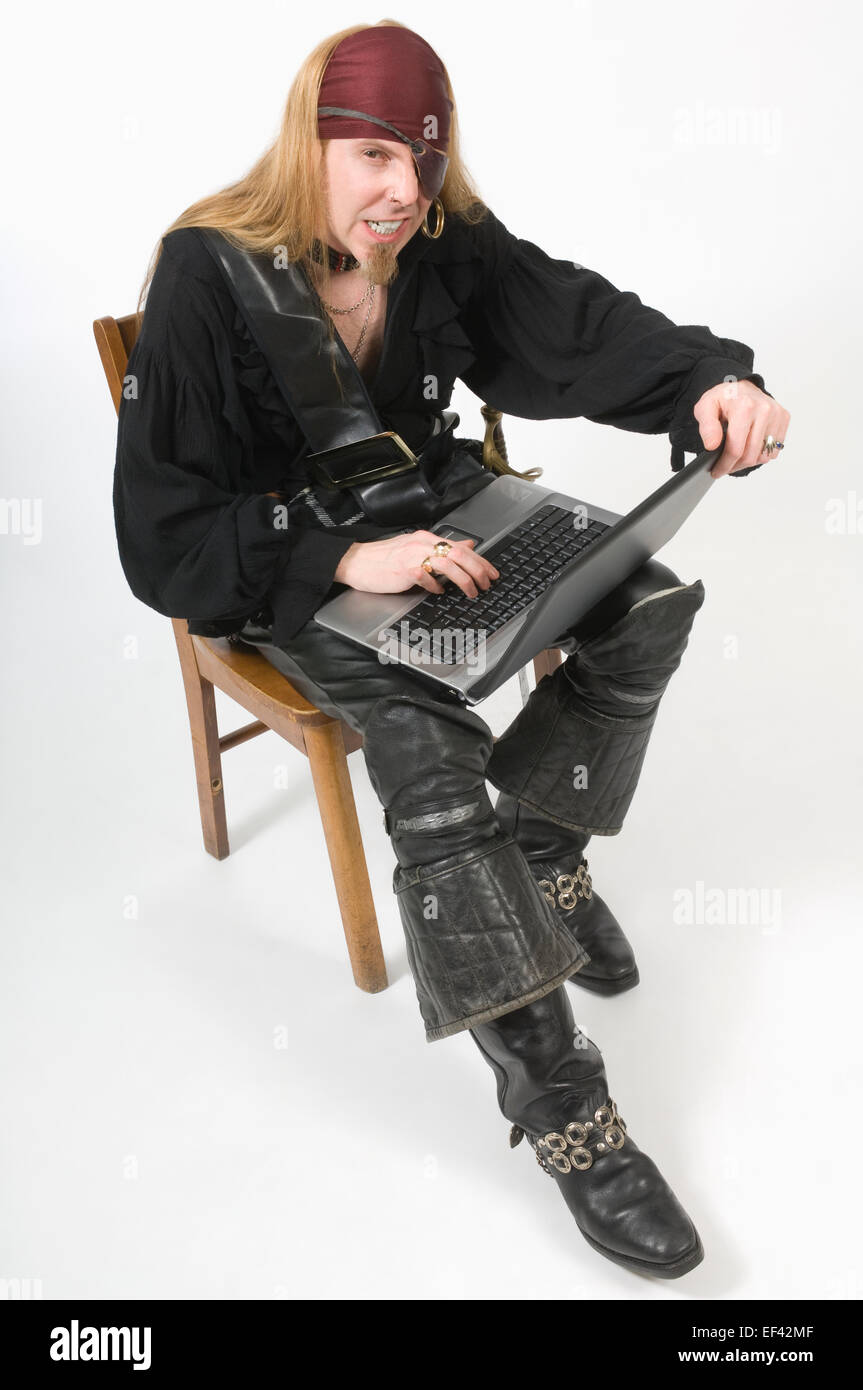 Pirate typing on laptop Stock Photo