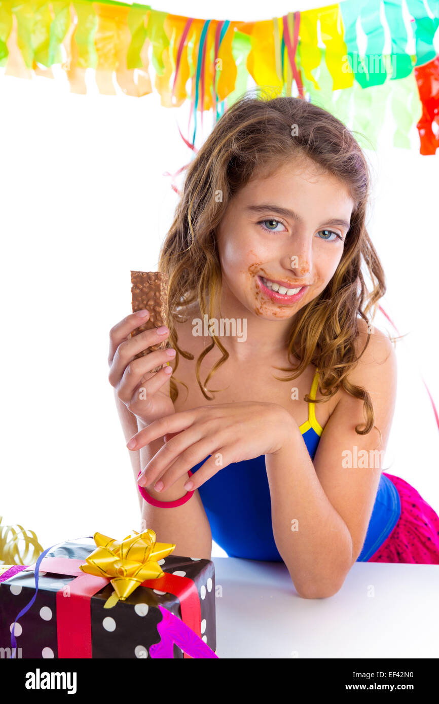 happy party girl with presents eating chocolate in birthday dirty mouth Stock Photo