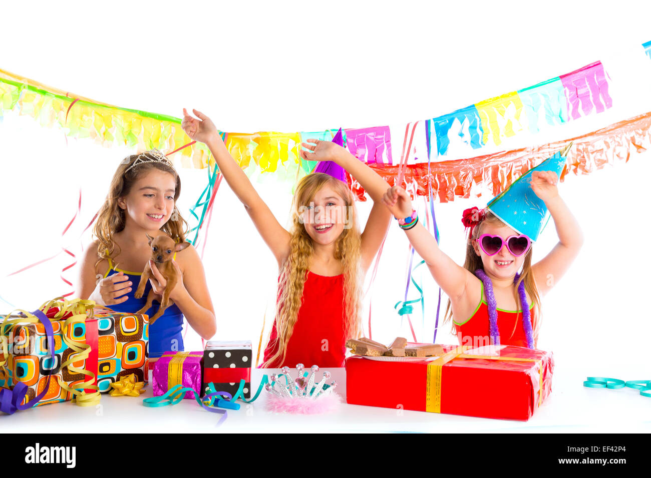 girl friends party dancing with presents and puppy chihuahua dog in birthday Stock Photo