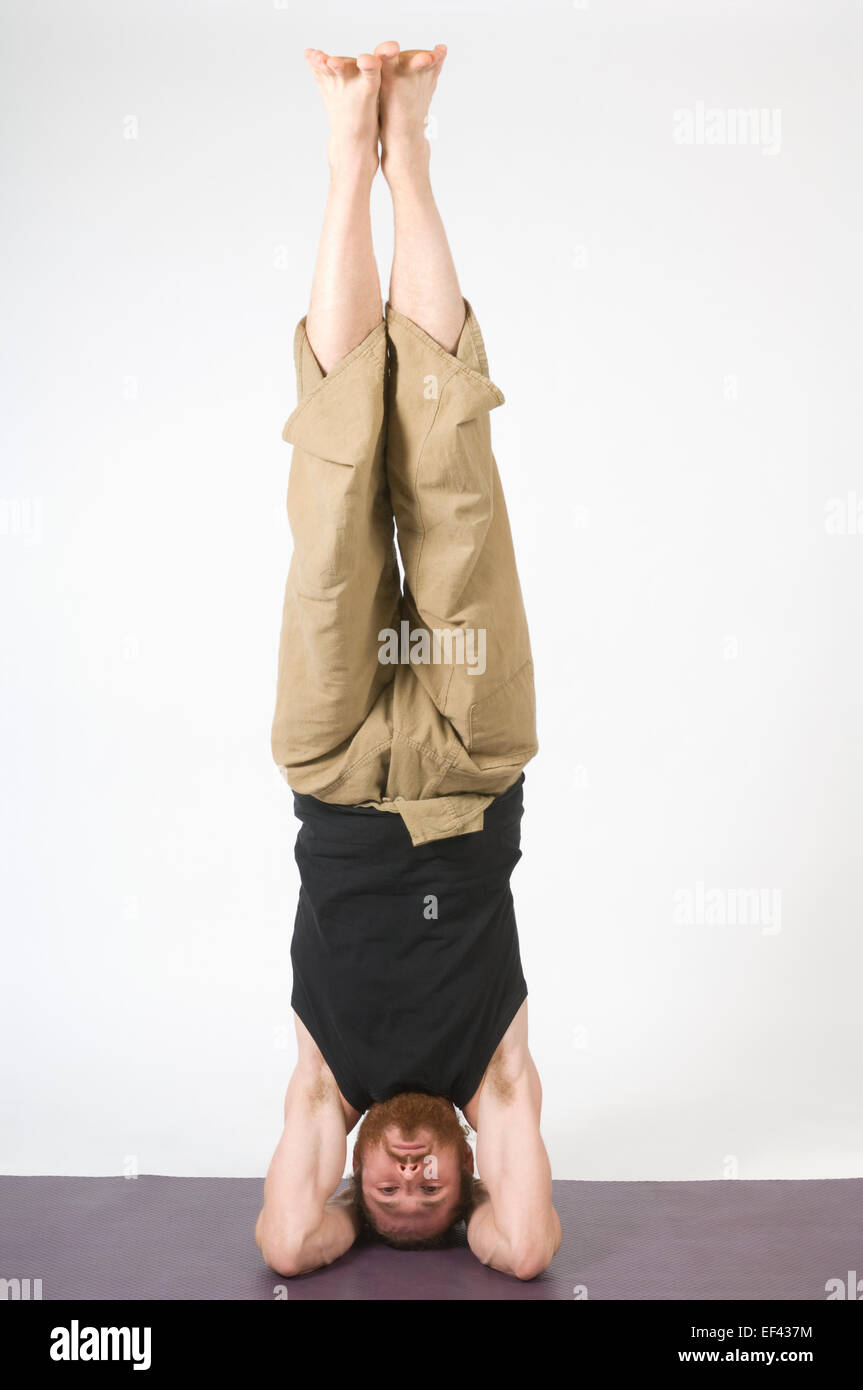 Man doing yoga Stock Photo