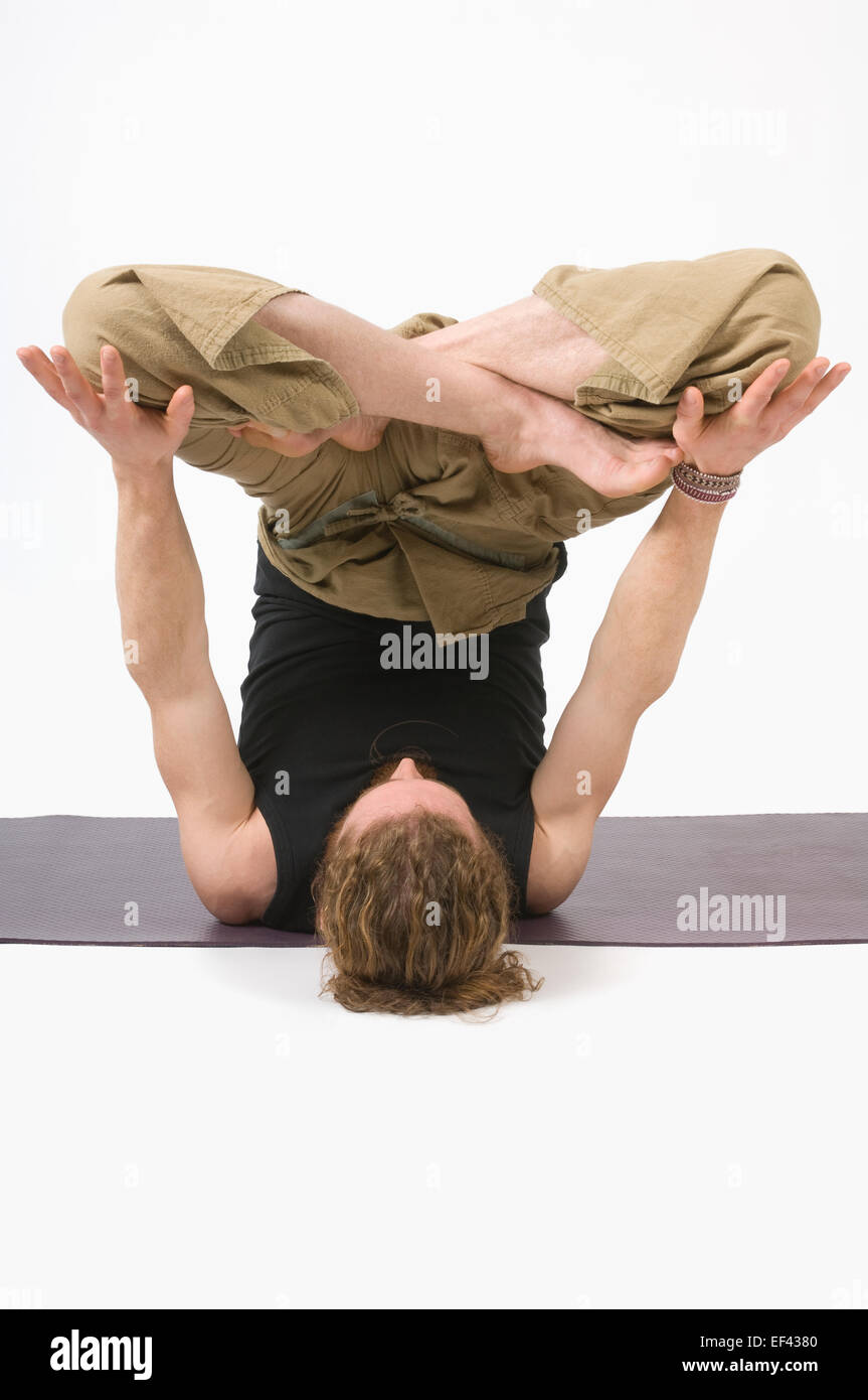Man doing yoga Stock Photo