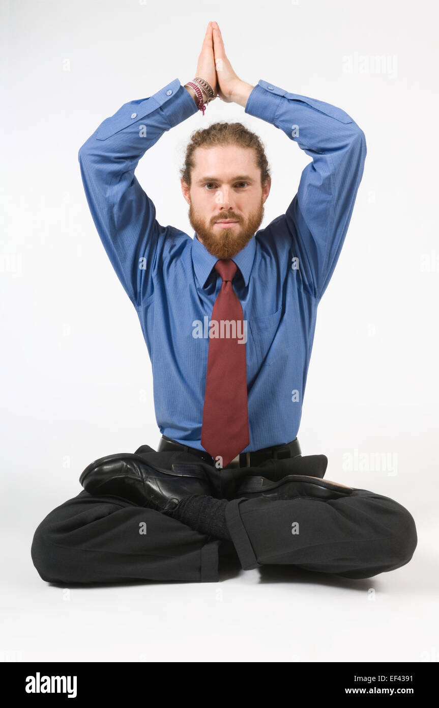 Businessman doing yoga Stock Photo - Alamy