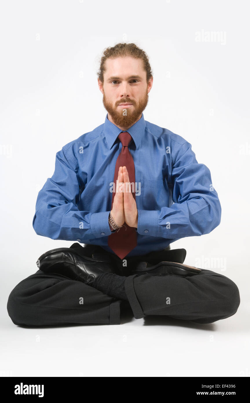 Businessman doing yoga Stock Photo