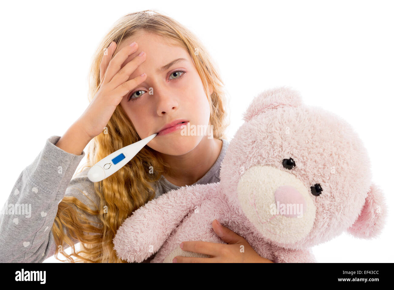 blond girl with thermometer and flu cold in pyjama grumpy face with ...