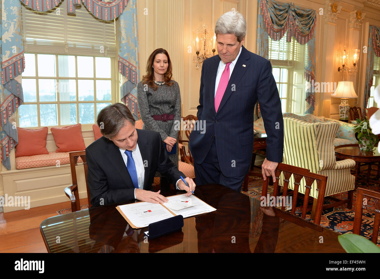 With his wife, Assistant Secretary of State for Educational and Cultural Affairs Evan Ryan, and U.S. Secretary of State John Kerry looking on, Antony Blinken signs his appointment papers to become the next Deputy Secretary of State, at the U.S. Department of State in Washington, D.C., on January 9, 2015. Stock Photo