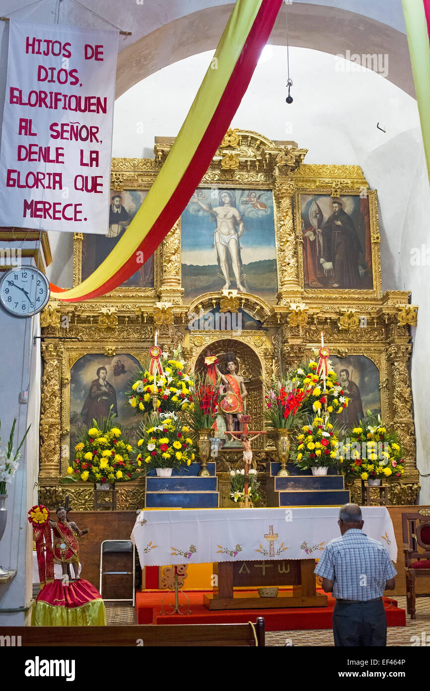 San Sebastian Abasolo, Oaxaca, Mexico - A man prays before mass at  San Sebastian Abasolo Catholic church. Stock Photo