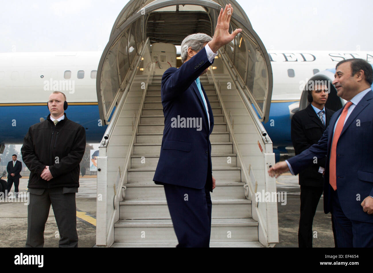 U.S. Secretary of State John Kerry waves goodbye to well-wishers as he departs from Islamabad, Pakistan, after meetings with government and military leaders and heads to Geneva, Switzerland, on January 13, 2015, to resume nuclear negotiations with Iranian Foreign Minister Javad Zarif. Stock Photo