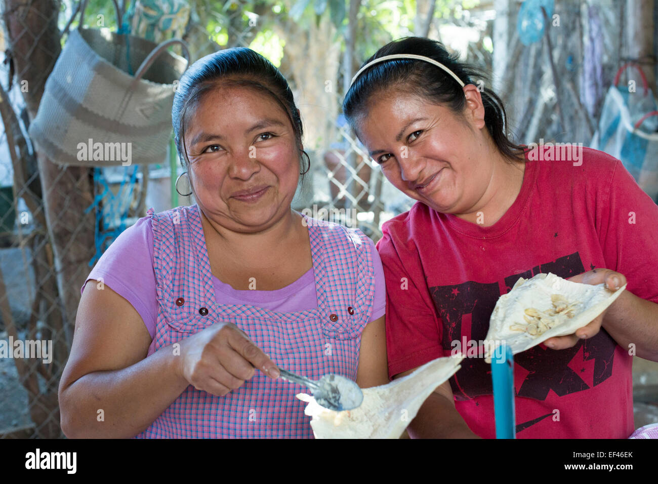 San Sebastian Abasolo, Oaxaca, Mexico - Women make tamales for a meal during the yearly celebration of San Sebastian. Stock Photo