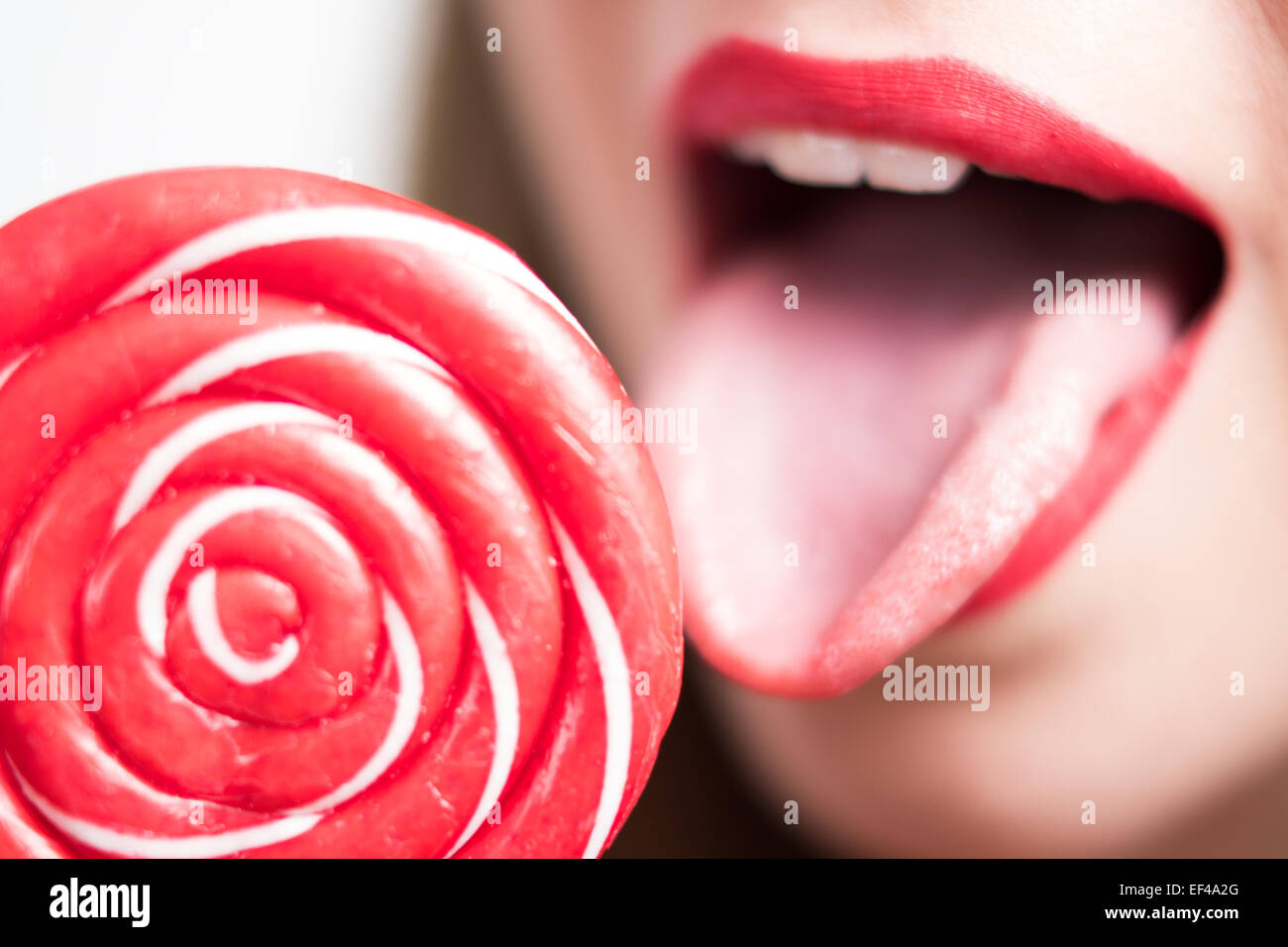 young woman's lips and a lollipop Stock Photo
