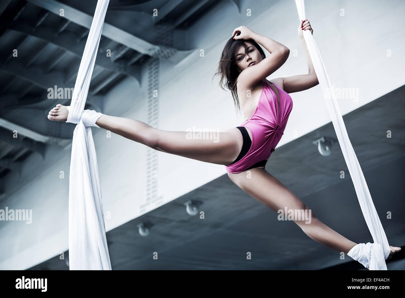 Young woman gymnast. On industrial background. Stock Photo