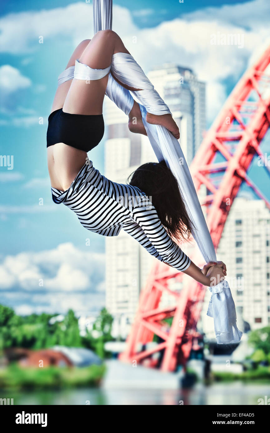 Young woman gymnast. On urban background. Stock Photo