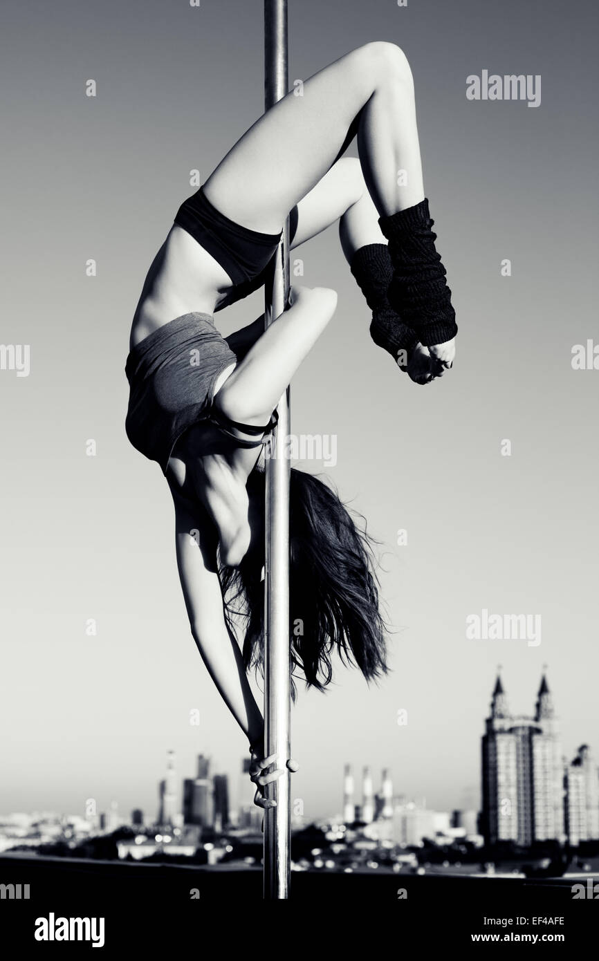 Young pole dance woman on urban background. Black and white. Stock Photo