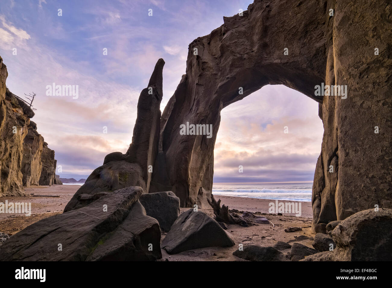 Arch in sandstone bluffs at Floras Lake State Natural Area on the southern Oregon coast. Stock Photo