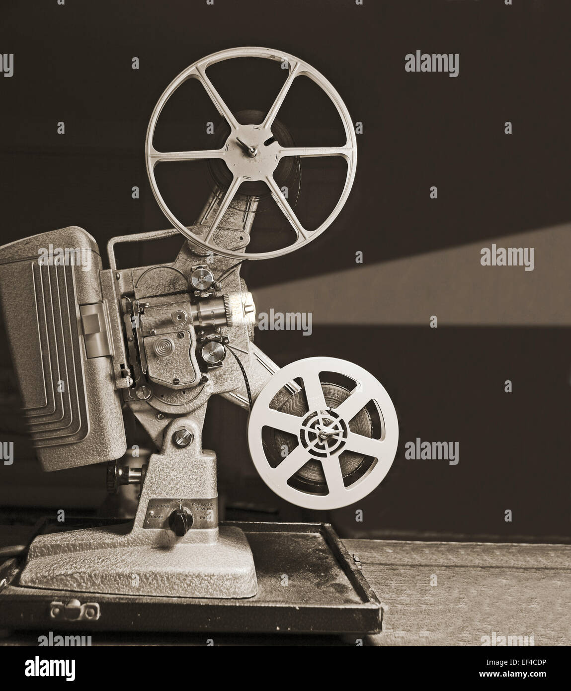 Film reels on a vintage 8mm film projector in a dark room Stock
