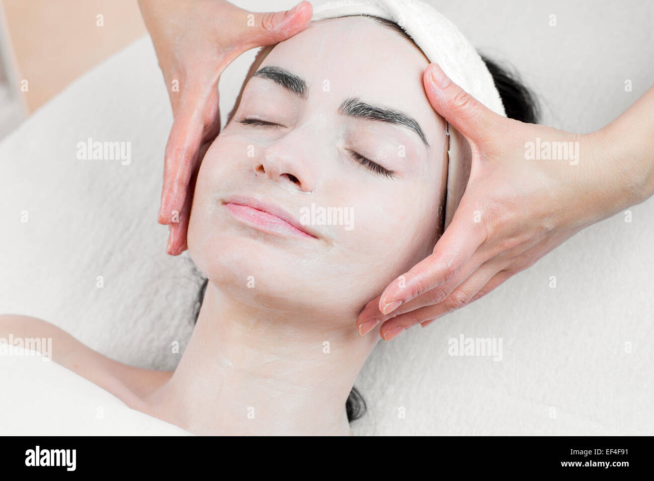 Young woman face massage in spa parlour Stock Photo