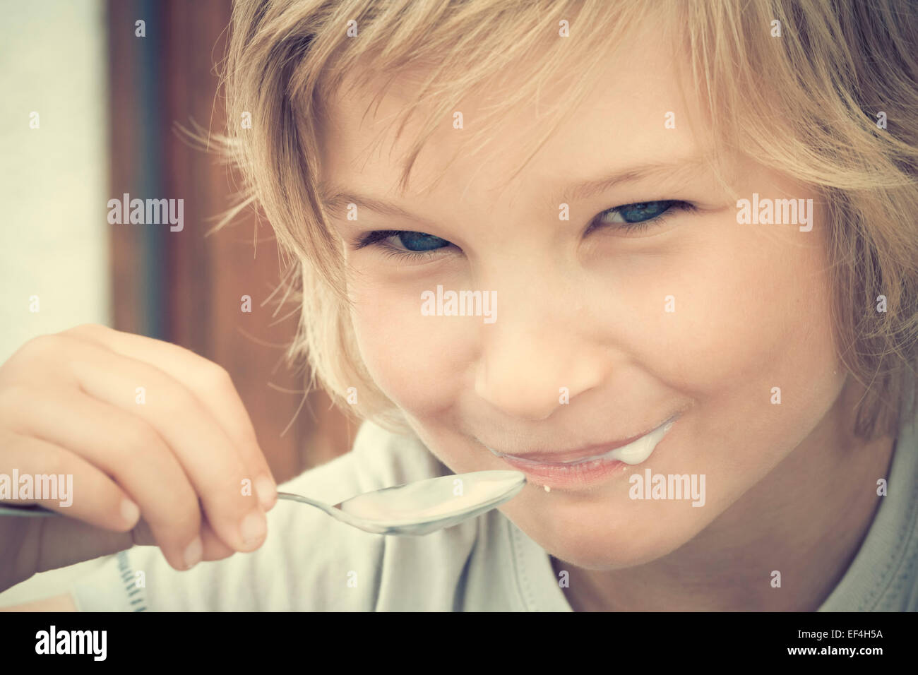 boy eating yogurt, closeup, 6 years old Stock Photo Alamy