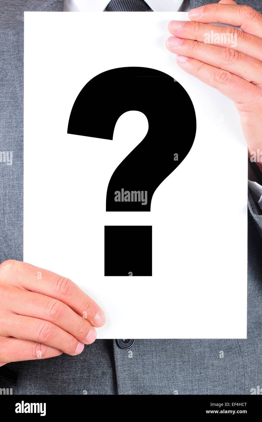 a man wearing a suit  holding a signboard with a question mark on it Stock Photo