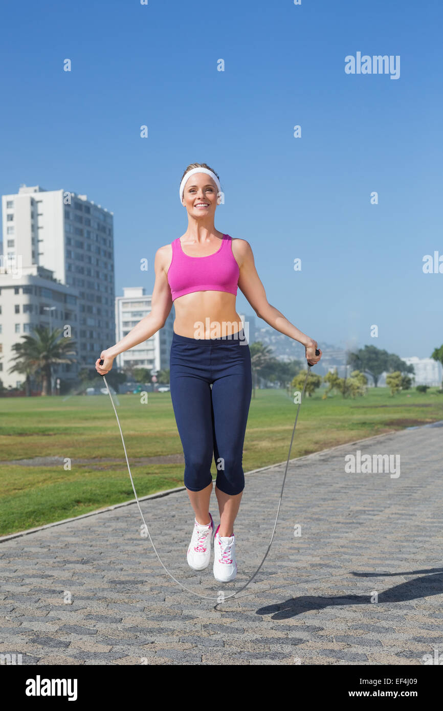 Fit blonde skipping rope on the pier Stock Photo - Alamy