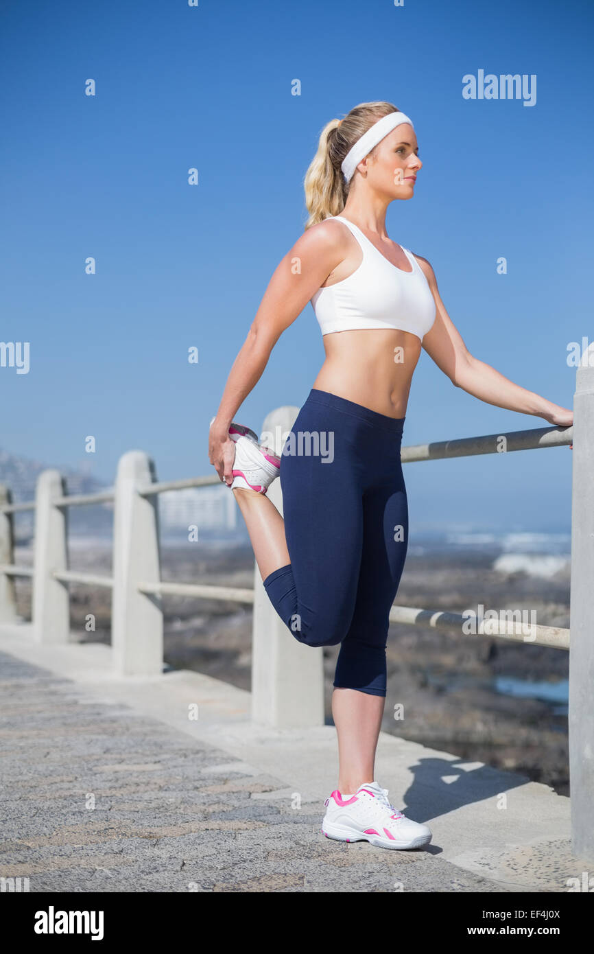Fit blonde stretching on the pier Stock Photo - Alamy
