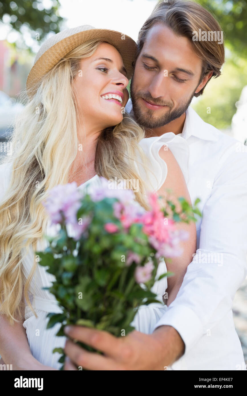 Attractive couple smiling at flowers Stock Photo - Alamy