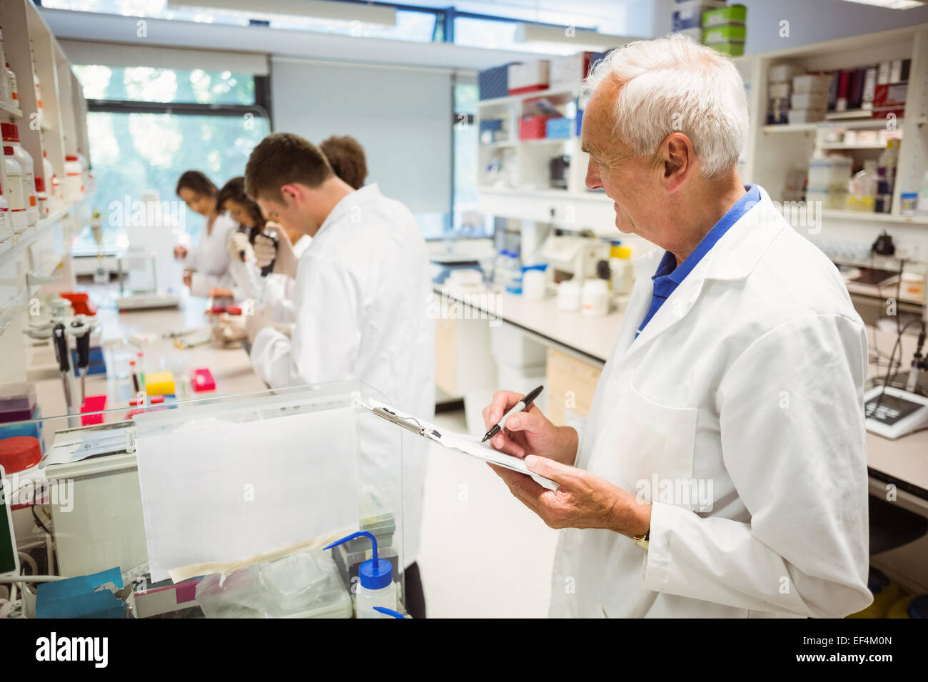 Lecturer watching over his science class Stock Photo Alamy