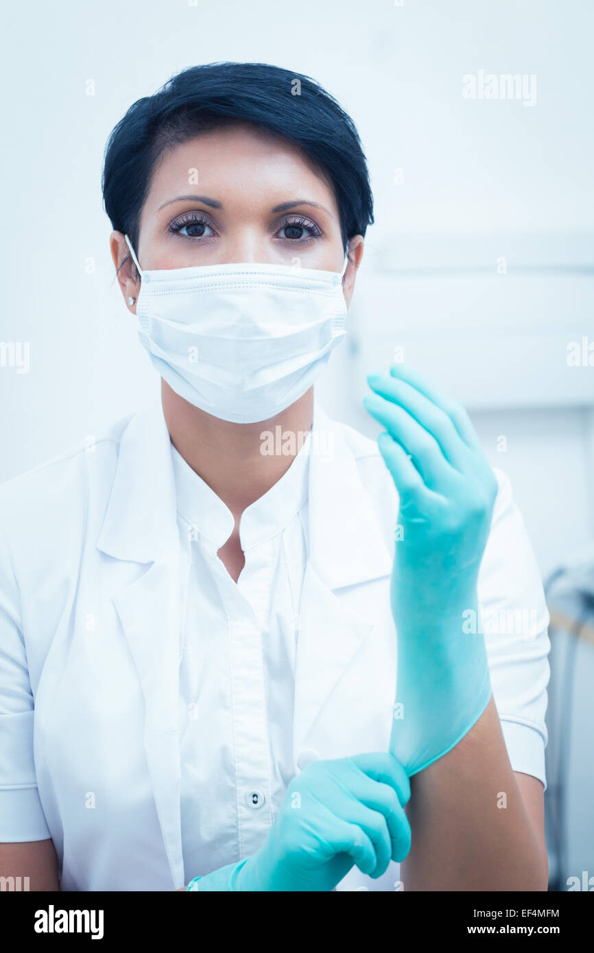 Female dentist wearing surgical mask and gloves Stock Photo - Alamy