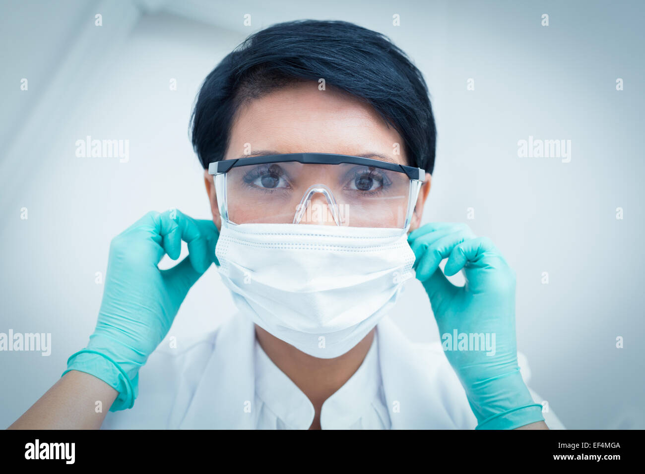 Dentist wearing surgical mask and safety glasses Stock Photo - Alamy