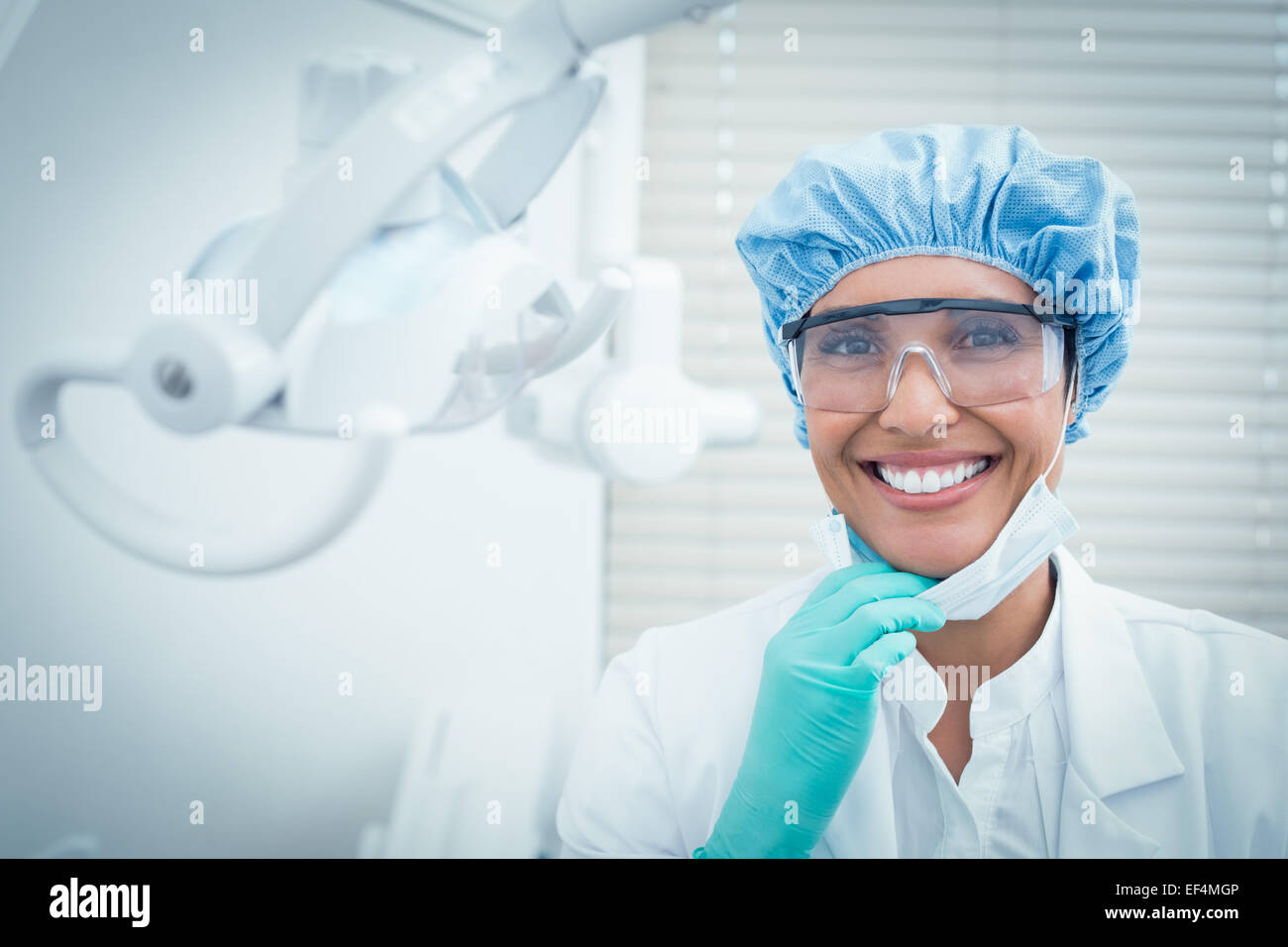 Female dentist wearing surgical cap and safety glasses Stock Photo Alamy