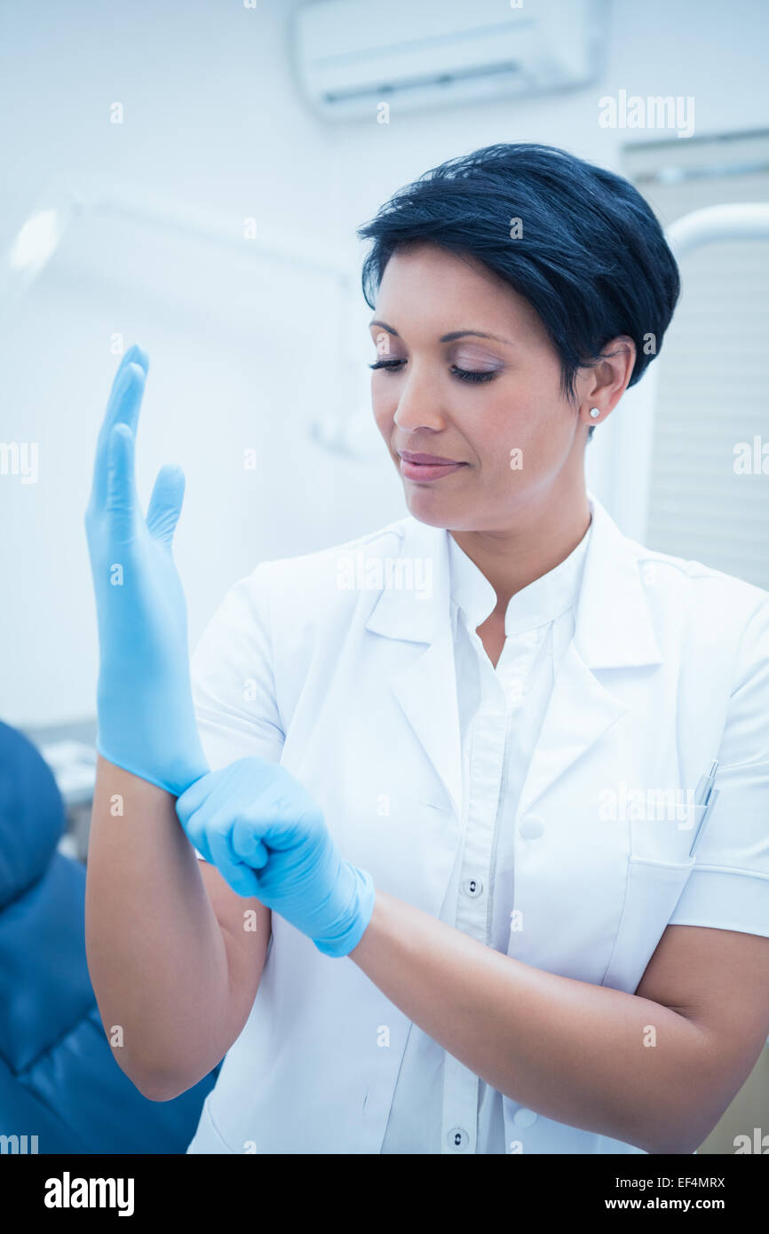 Dentist wearing surgical glove Stock Photo Alamy