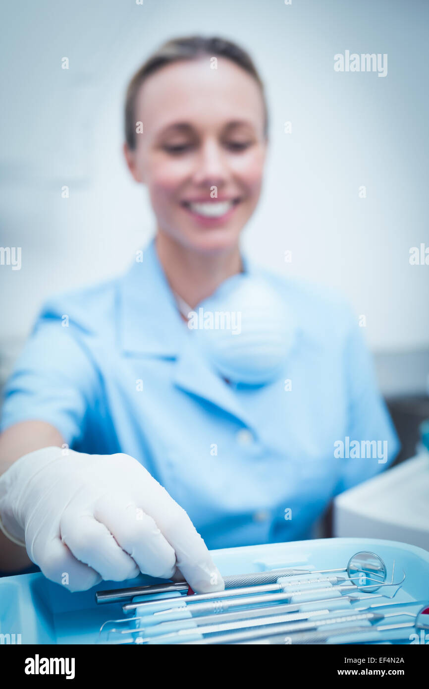 Female dentist picking dental tools Stock Photo Alamy