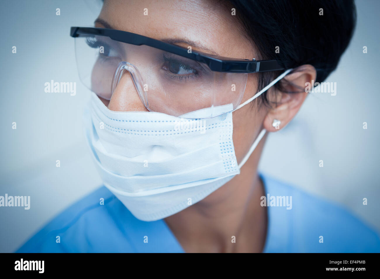 Female dentist wearing surgical mask and safety glasses Stock Photo Alamy