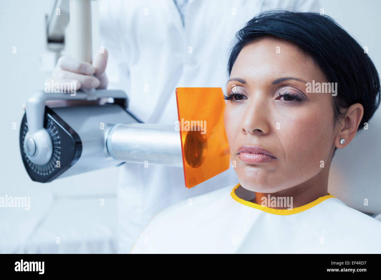 Serious young woman undergoing dental checkup Stock Photo