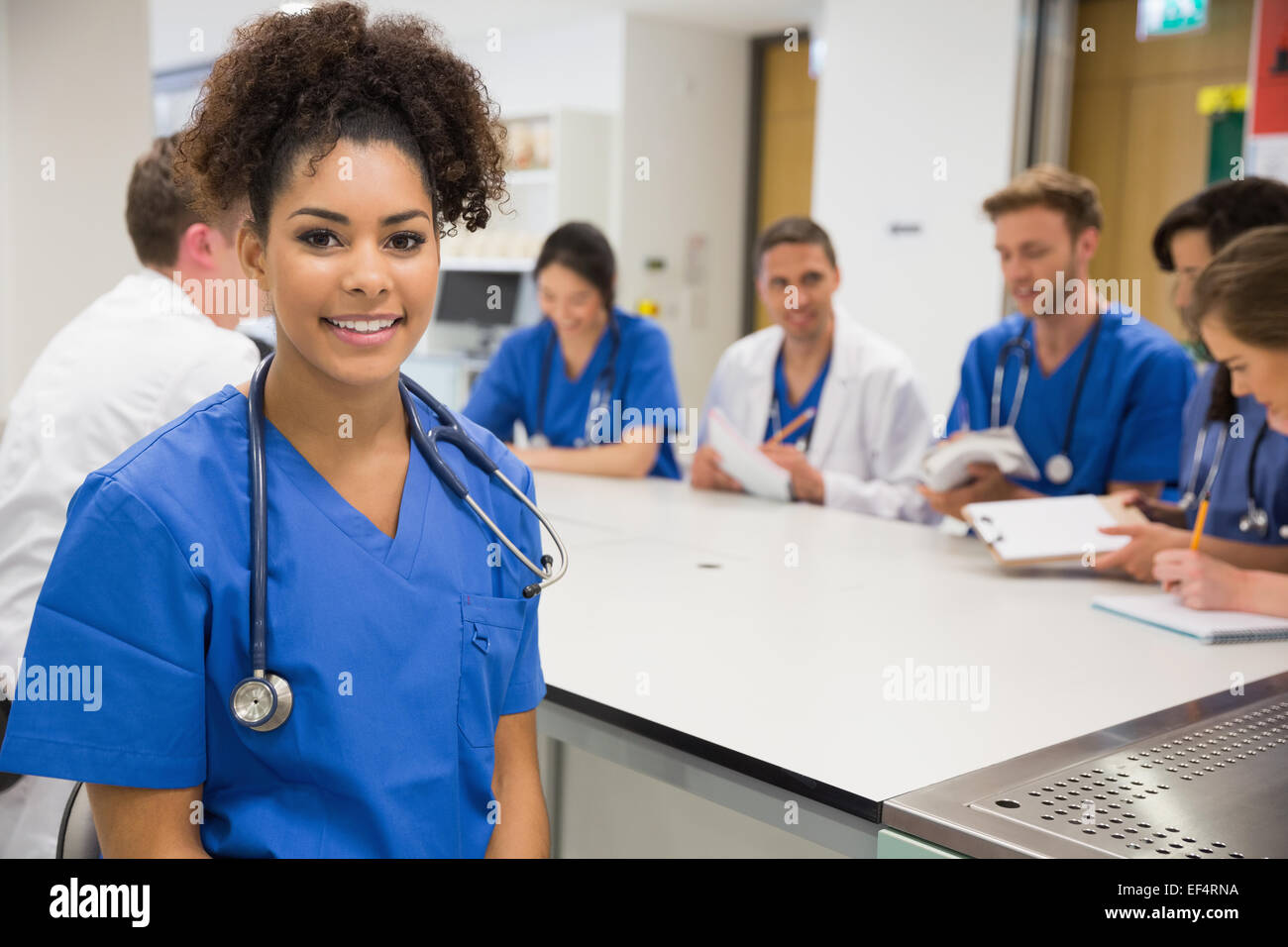 Medical student smiling at the camera during class Stock Photo - Alamy