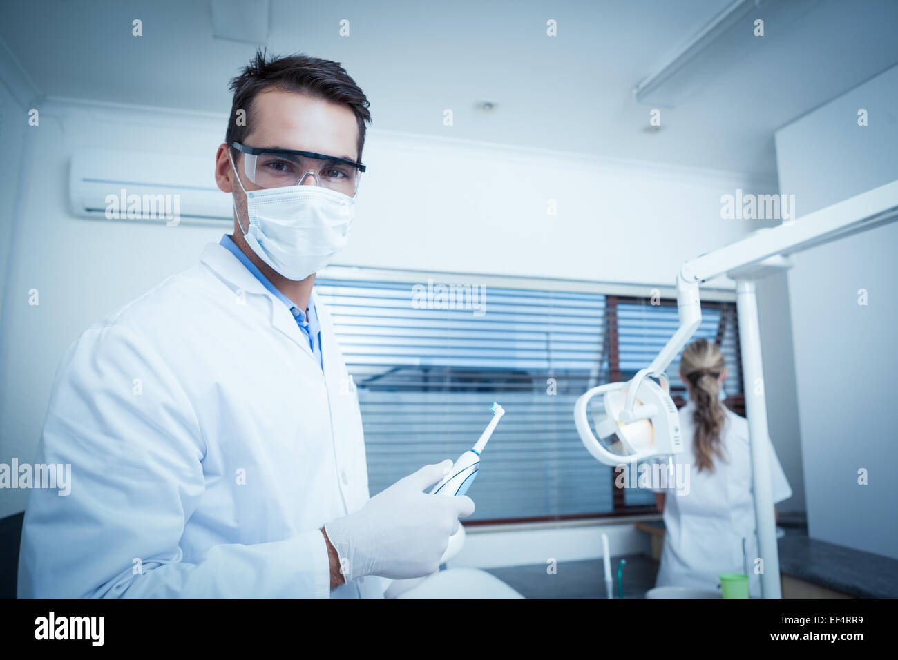 Male dentist wearing surgical mask Stock Photo Alamy