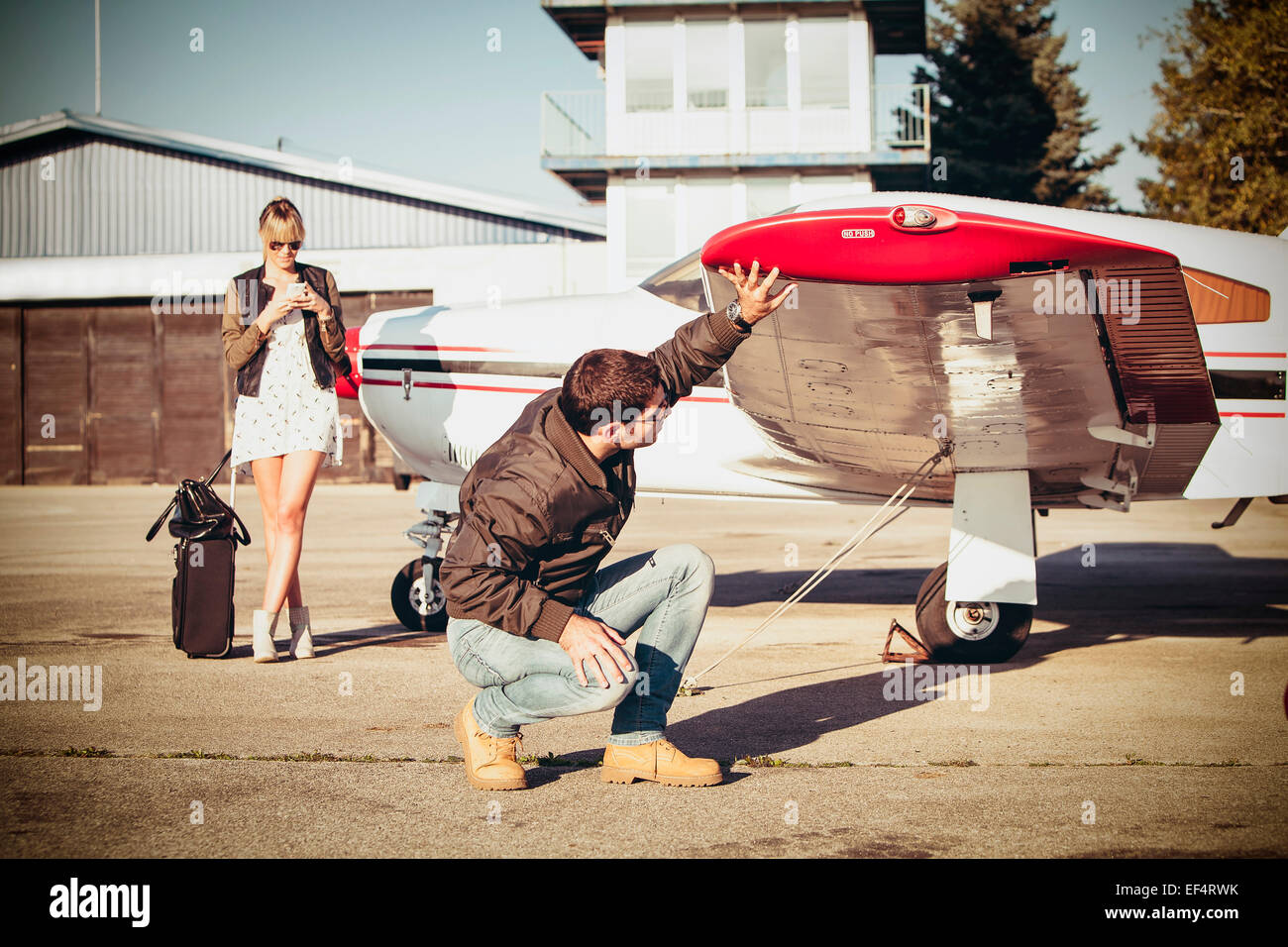 Pilot checking wing of propeller airplane Stock Photo Alamy