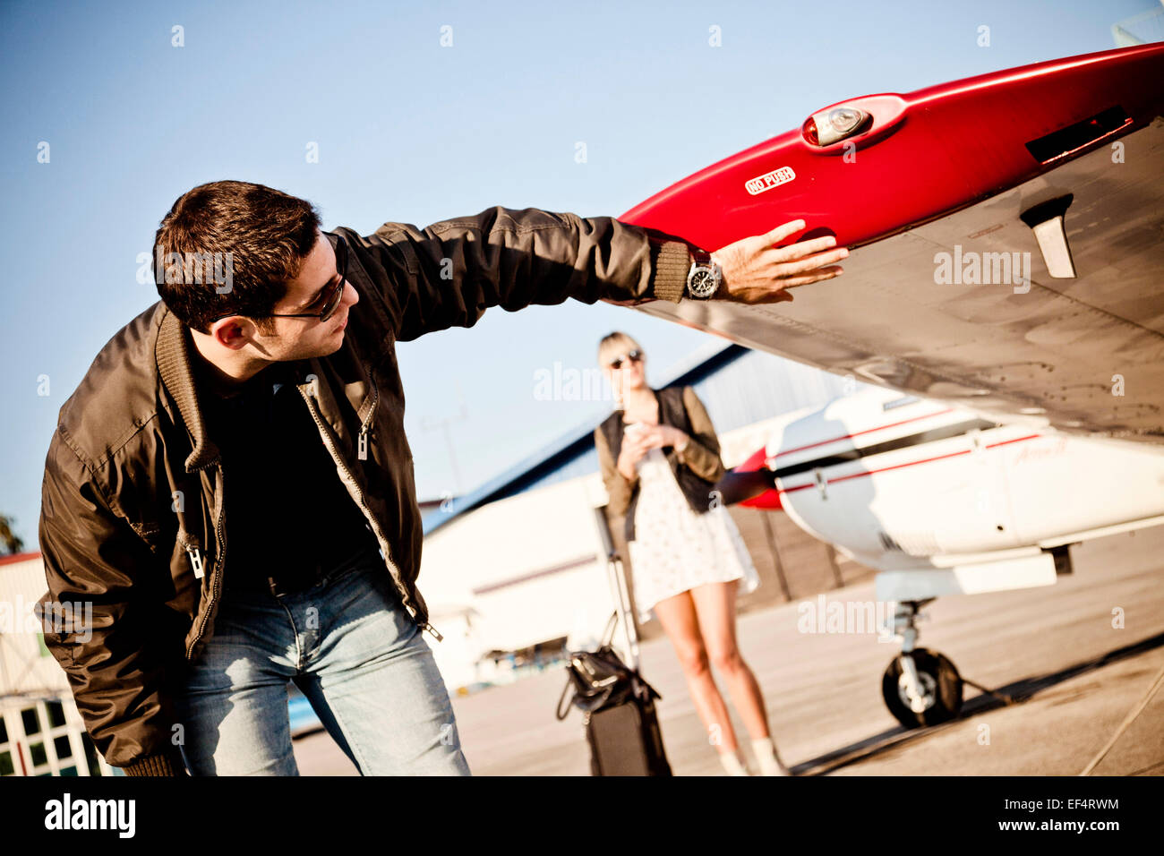Pilot checking wing of propeller airplane Stock Photo Alamy
