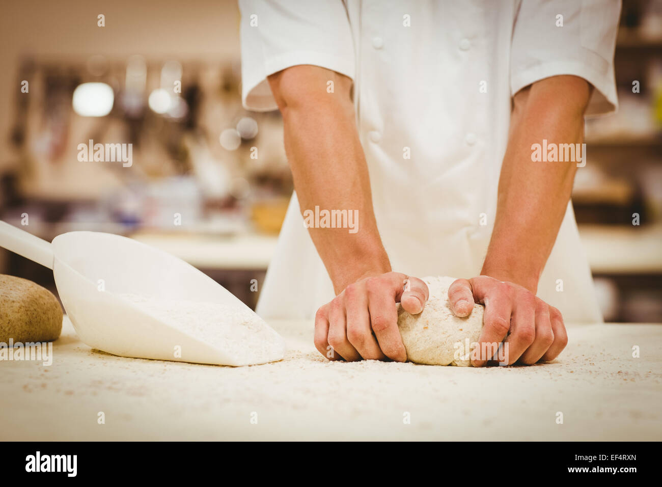 Baker kneading dough at a counter Stock Photo Alamy