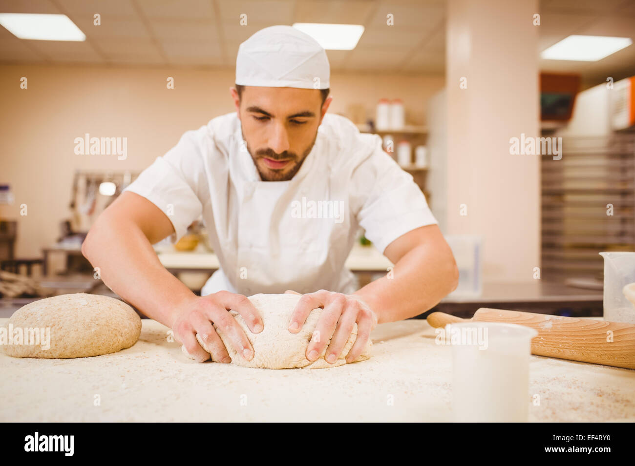 Baker kneading dough at a counter Stock Photo Alamy