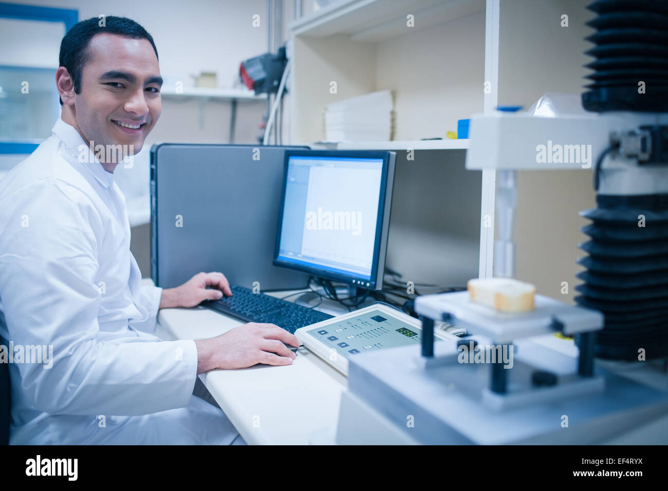 Young happy scientist sitting hi-res stock photography and images - Alamy