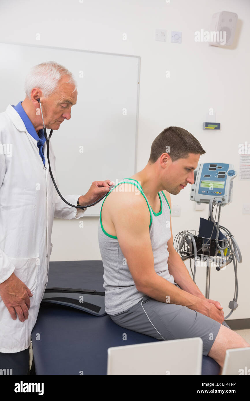 Doctor listening to patient with stethoscope Stock Photo Alamy
