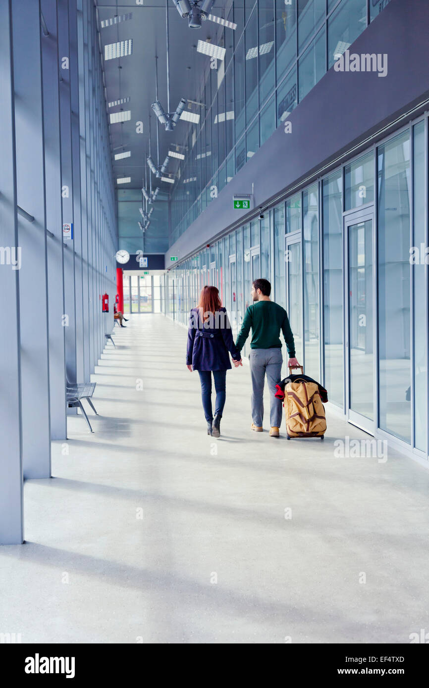 Man walking through airport with luggage hi-res stock photography and ...