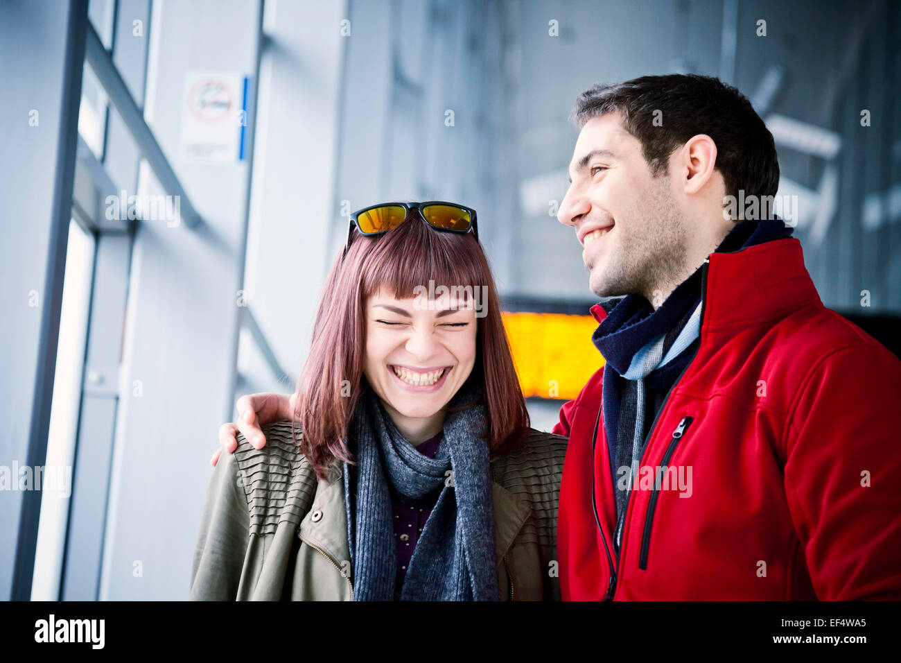 Happy young couple in airport building Stock Photo