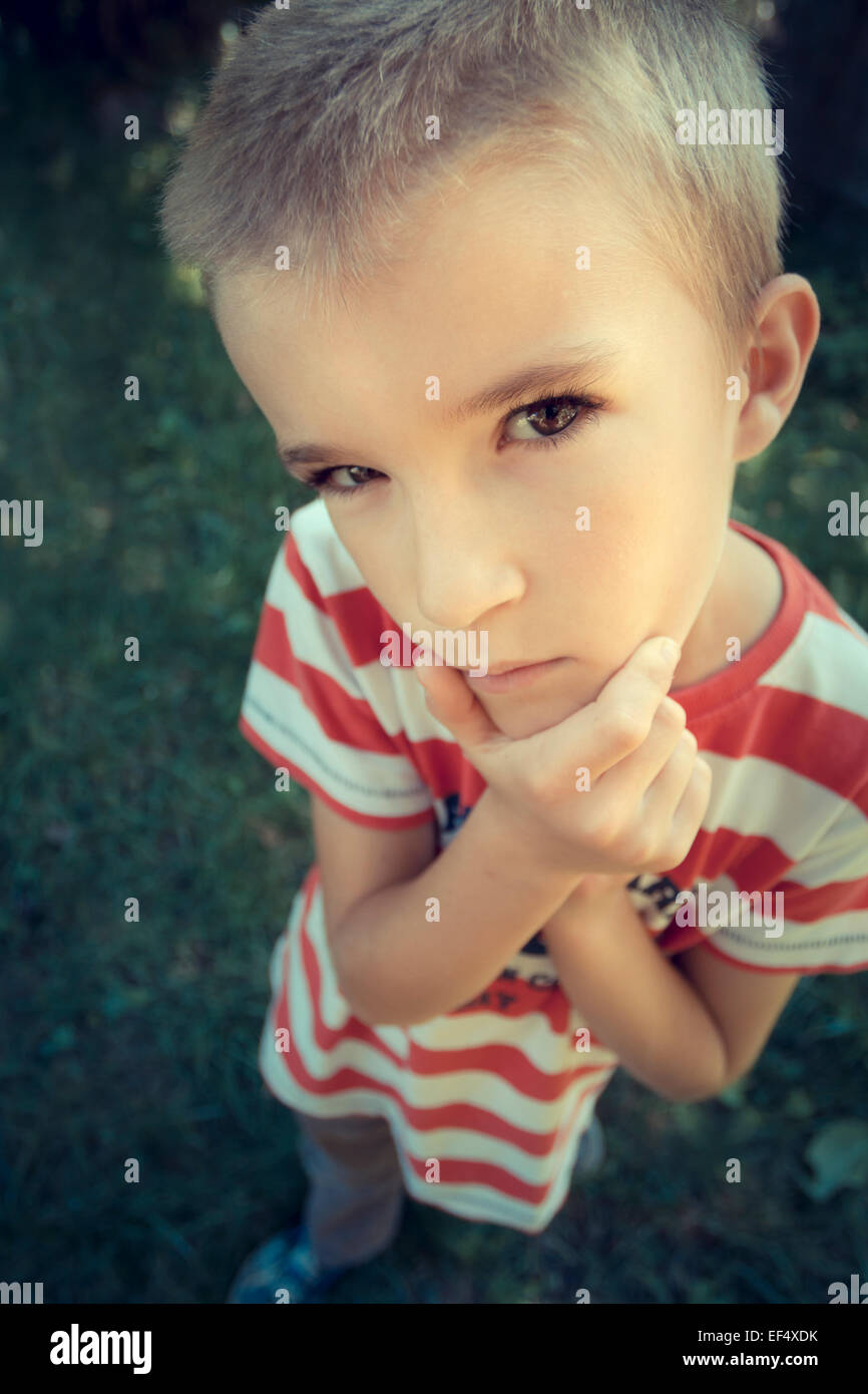 Young Boy Outdoors Thinking Stock Photo - Alamy