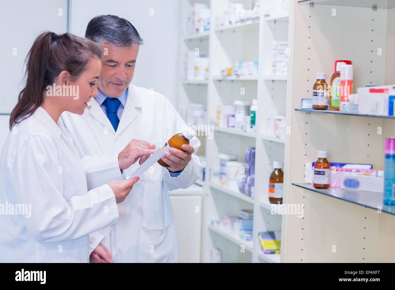Pharmacist and trainee talking together about medication Stock Photo